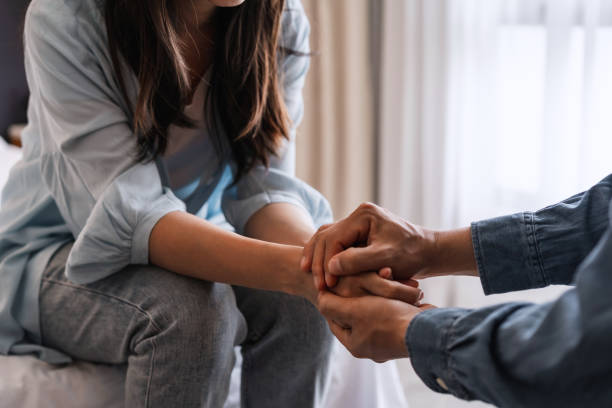 Couple holding hands. Trauma survival mode creates distance in relationships. Healing requires reconnecting.